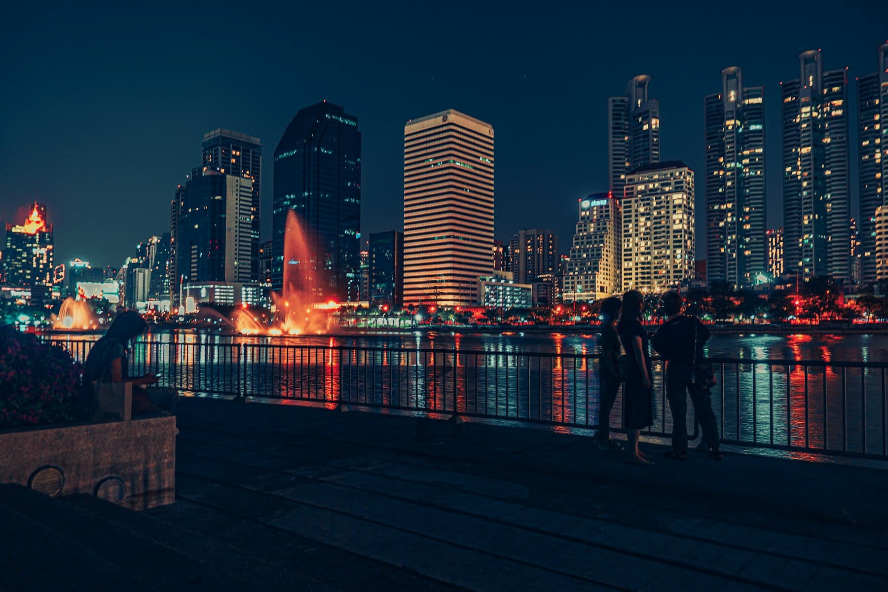 The Sukhumvit skyline seen across the water at Benjakitti Park