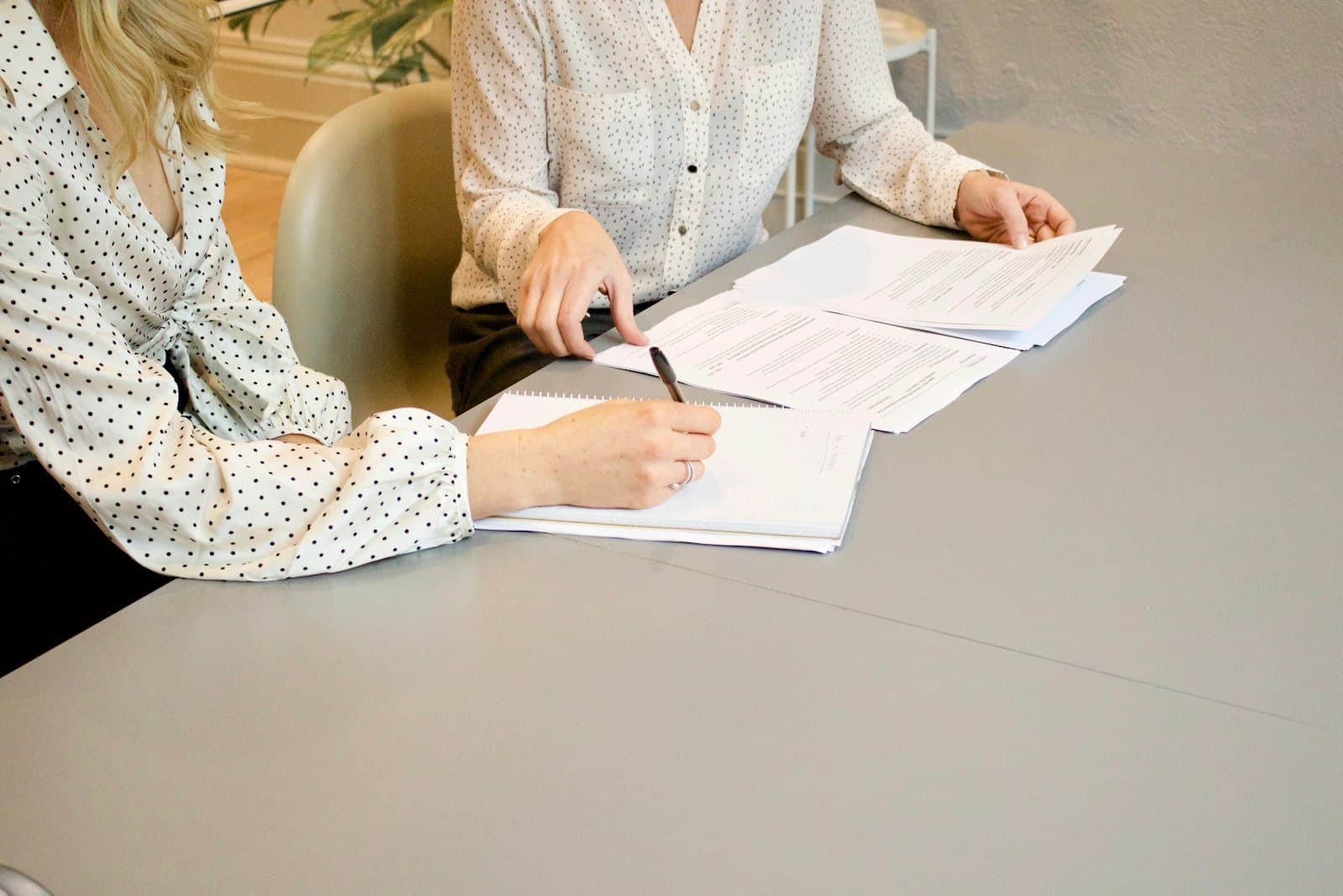 Two people going through documents together before signing
